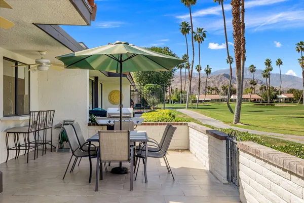 a view of a patio with a table chairs and a patio
