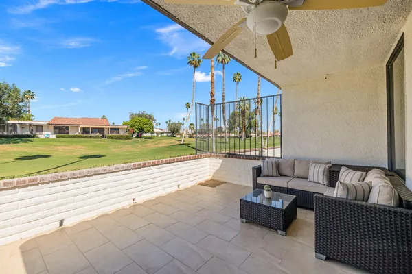 a view of an outdoor space with furniture and umbrella