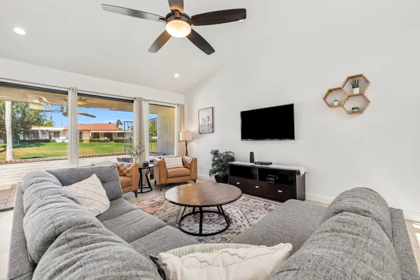 a living room with furniture and a flat screen tv