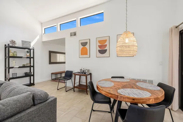 a living room with furniture and a dining table