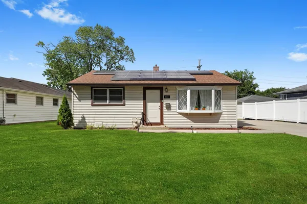 a front view of a house with a garden and deck