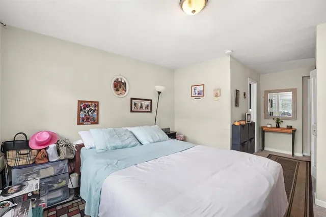 a bedroom with a bed and a mirror