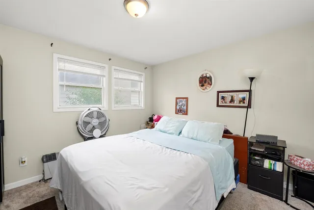 a bedroom with a bed and a table