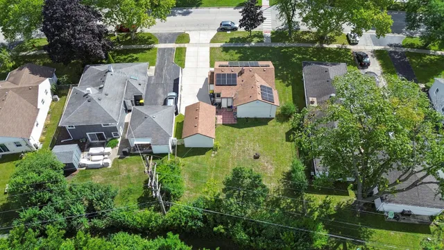 an aerial view of house with yard swimming pool and outdoor seating