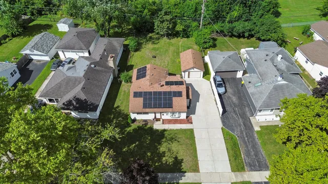 an aerial view of a house with outdoor space and street view