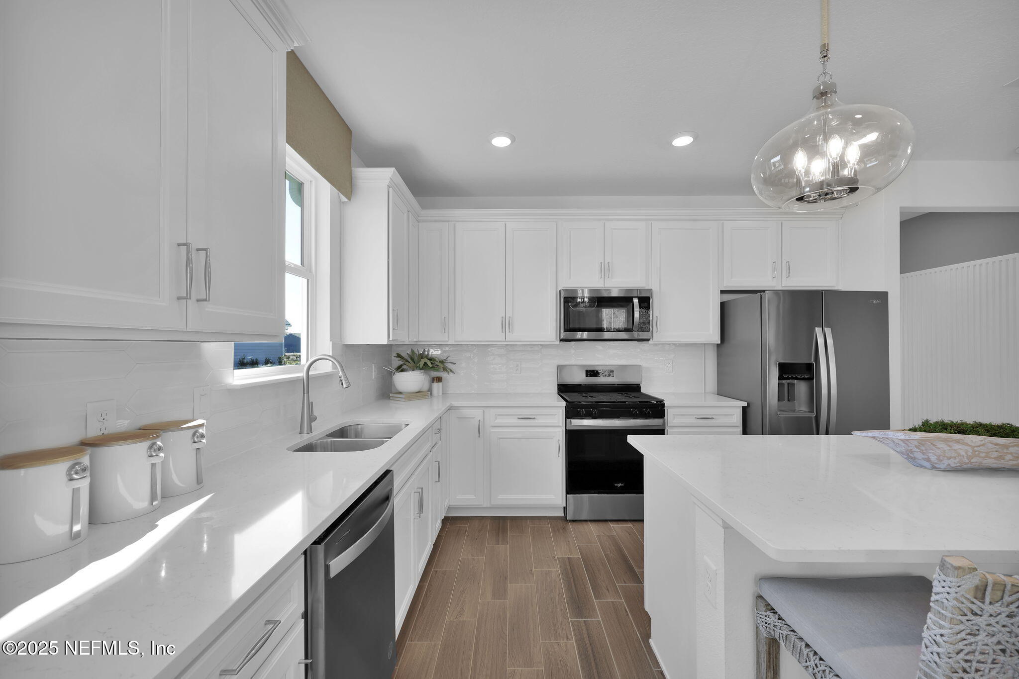 1745 Mickey Way Middleburg, FL 32068 - Photo 12 of 30 a kitchen with stainless steel appliances a sink stove and refrigerator