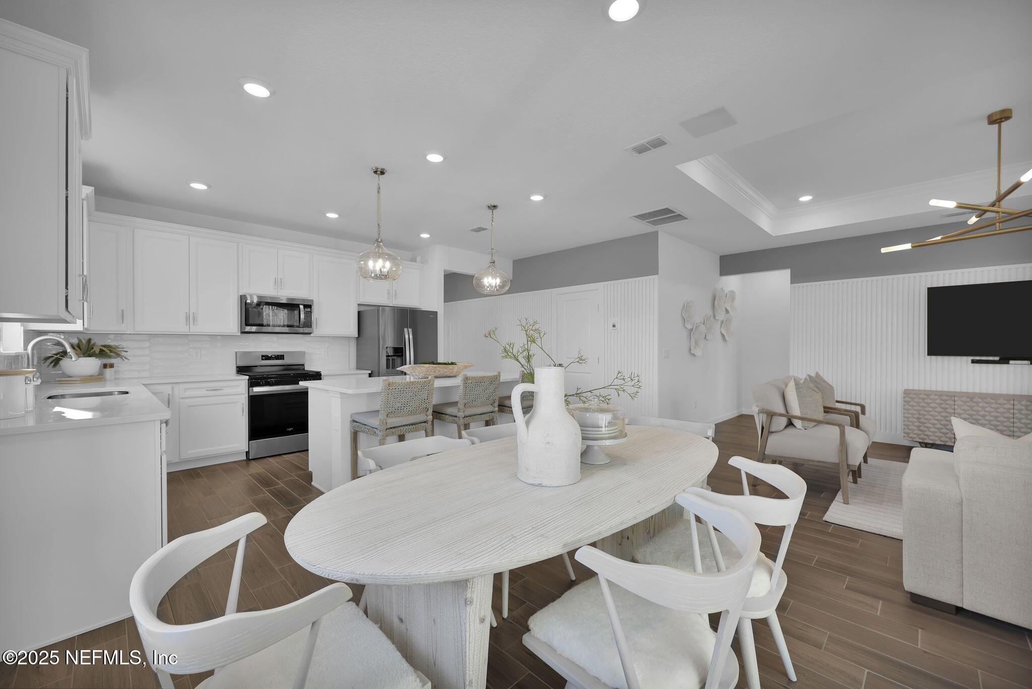 1745 Mickey Way Middleburg, FL 32068 - Photo 15 of 30 a kitchen with stainless steel appliances kitchen island granite countertop a dining table chairs and microwave
