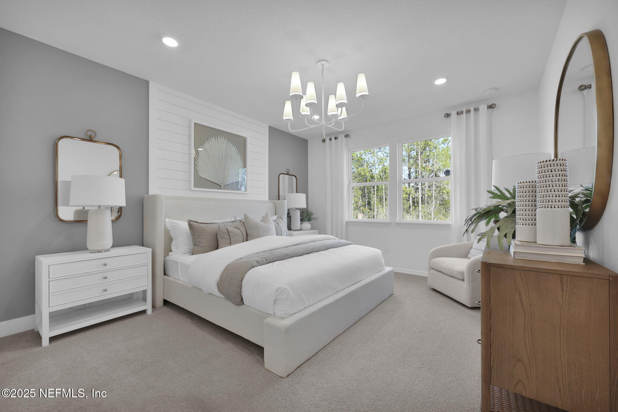 1745 Mickey Way Middleburg, FL 32068 - Photo 23 of 30 a spacious bedroom with a bed and a chandelier