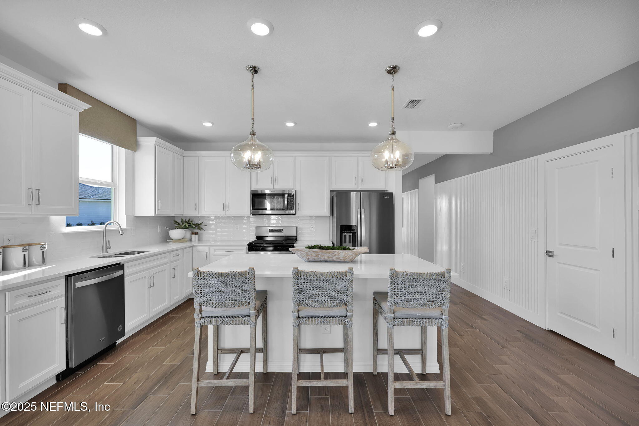1745 Mickey Way Middleburg, FL 32068 - Photo 7 of 30 a large kitchen with kitchen island a dining table and chairs