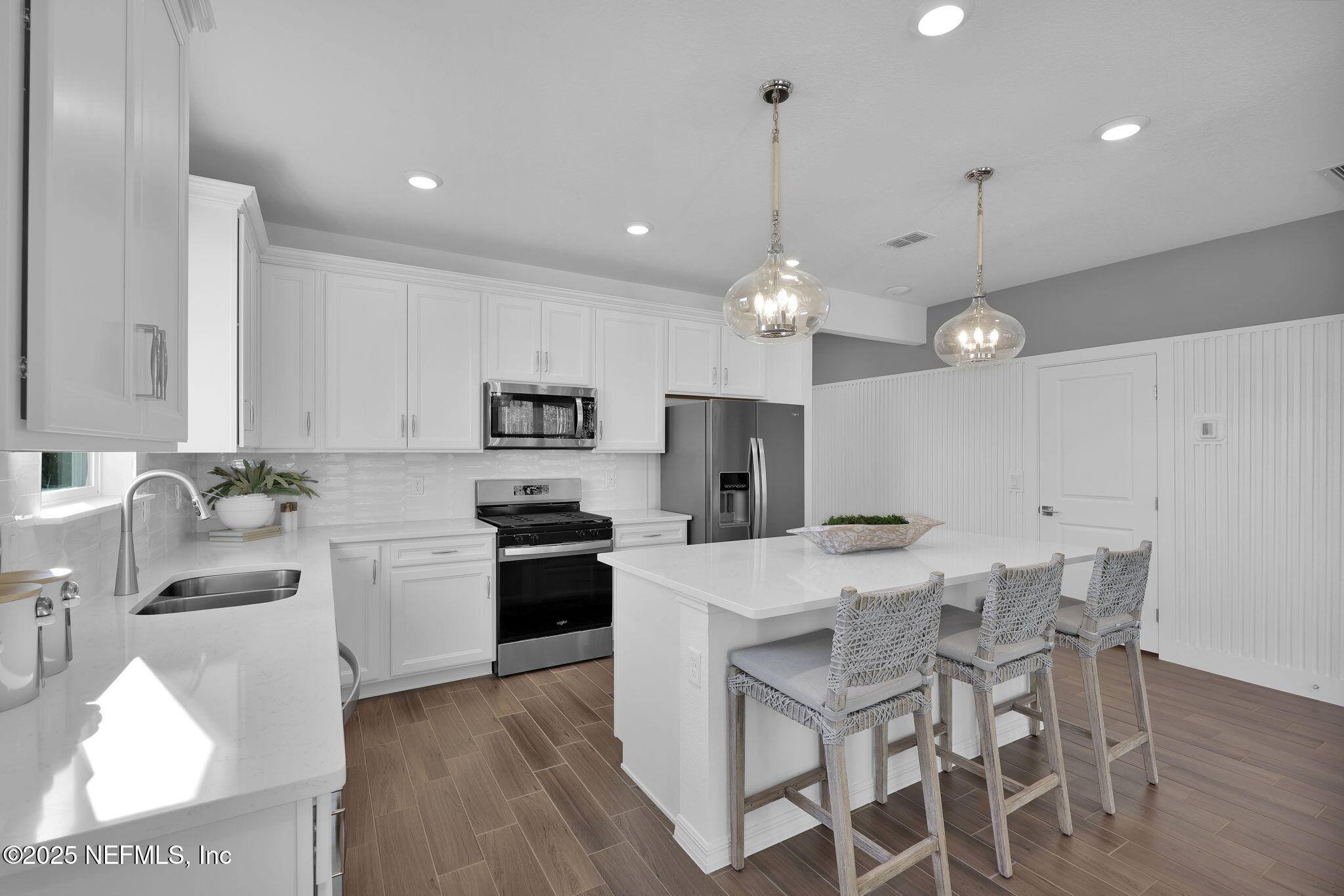 1745 Mickey Way Middleburg, FL 32068 - Photo 8 of 30 a kitchen with stainless steel appliances kitchen island granite countertop a sink a stove a dining table and chairs
