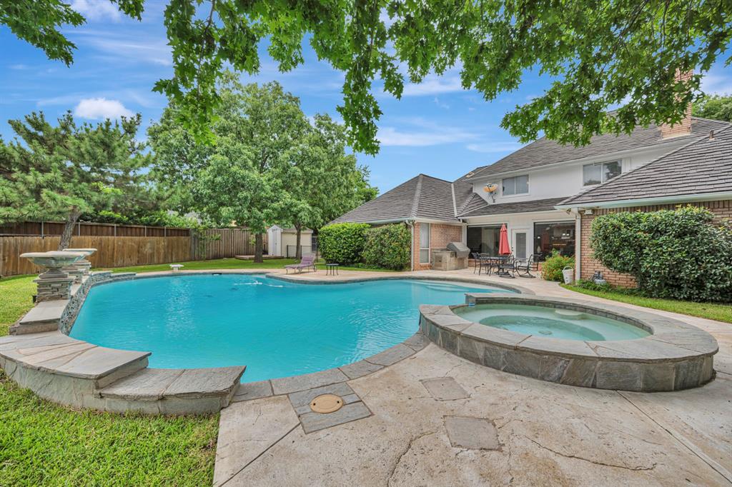 4008 Ramsgate Court Colleyville, TX 76034 - Photo 27 of 33 Private backyard retreat featuring a freeform swimming pool with integrated spa and stone coping