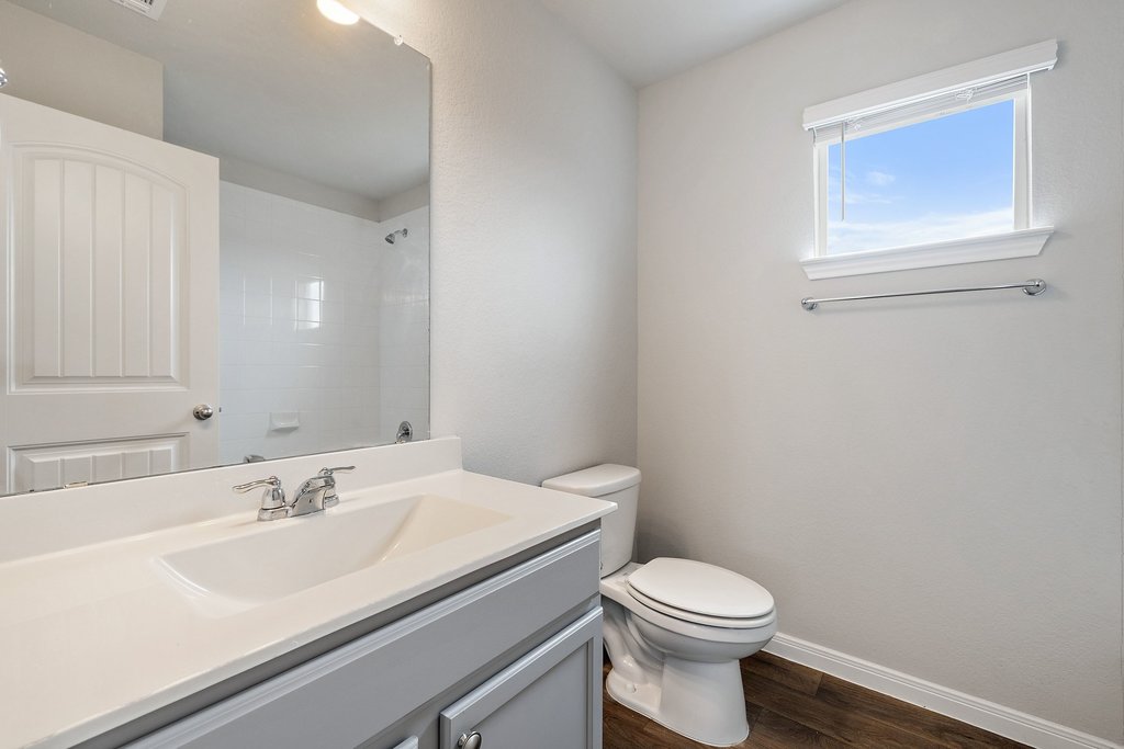102 Ashford Way Georgetown, TX 78626 - Photo 19 of 28 A well-lit bathroom with ample natural light offers a functional vanity and shower.