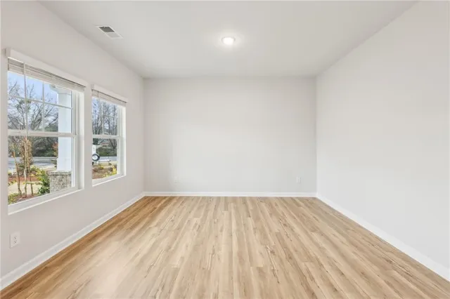 a view of room with window and hardwood floor