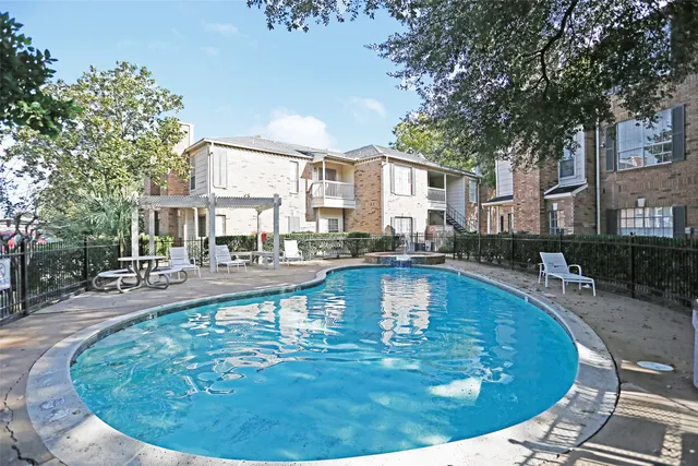 a view of a swimming pool with sitting area