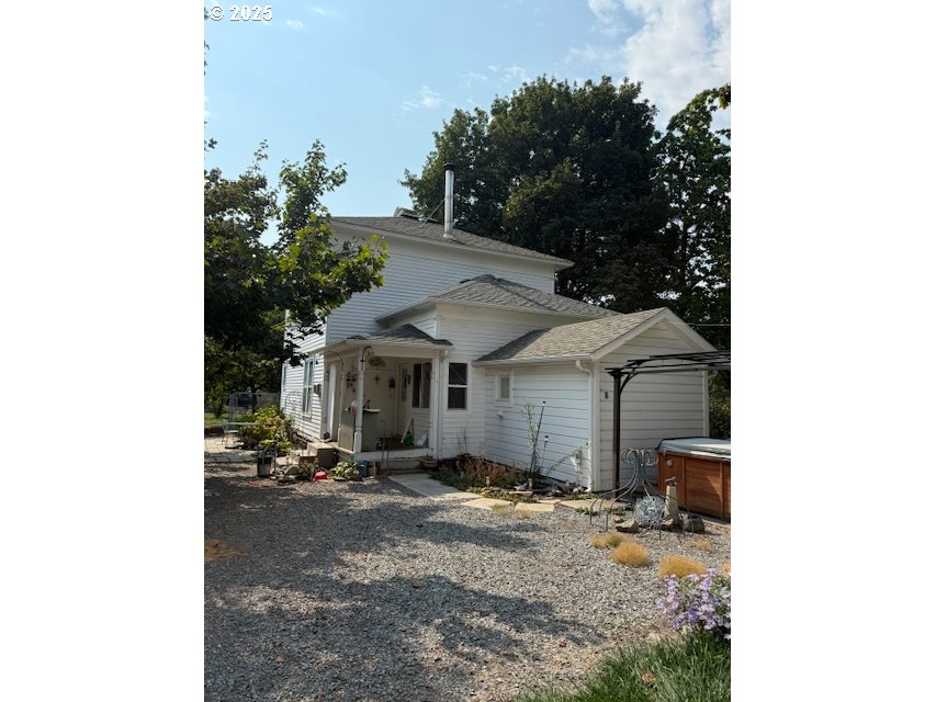 a view of a house with a yard and sitting area