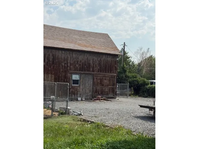 a backyard of a house with table and chairs