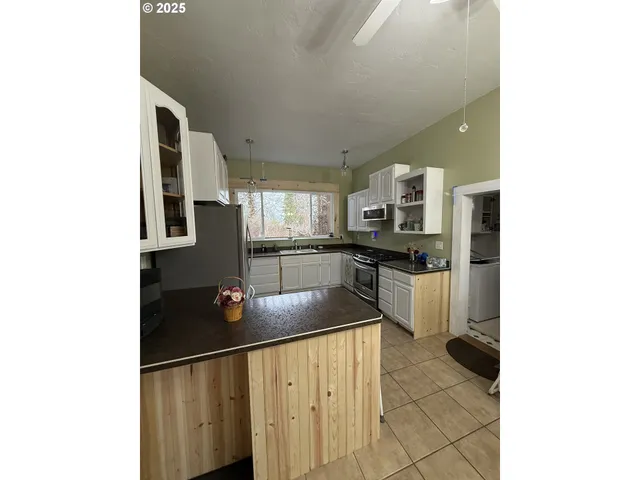 a kitchen with stainless steel appliances a refrigerator and a stove