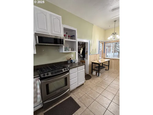 a kitchen with a stove and a refrigerator