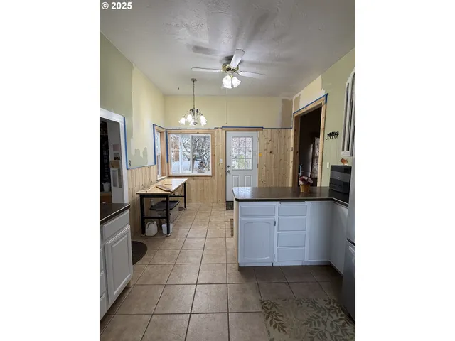 a living room with stainless steel appliances kitchen island granite countertop furniture and a kitchen view