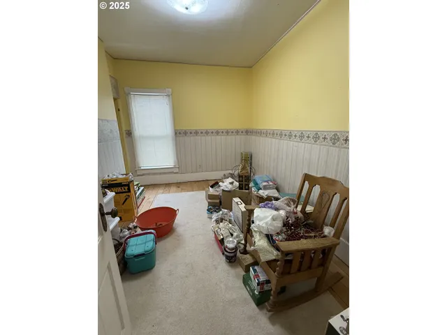 a balcony with chairs and a potted plant