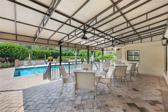 a view of a patio with a table and chairs