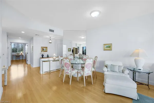 a dining room with furniture and wooden floor