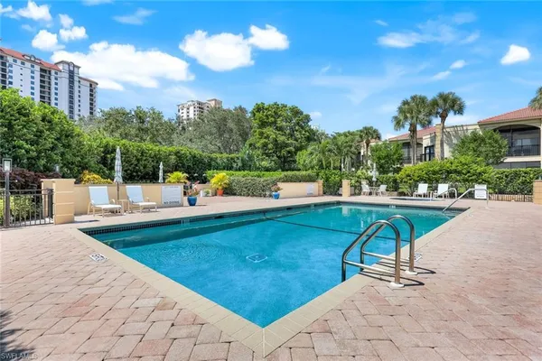 a view of a swimming pool with a patio and a garden