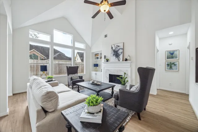 a living room with furniture fireplace and a large window