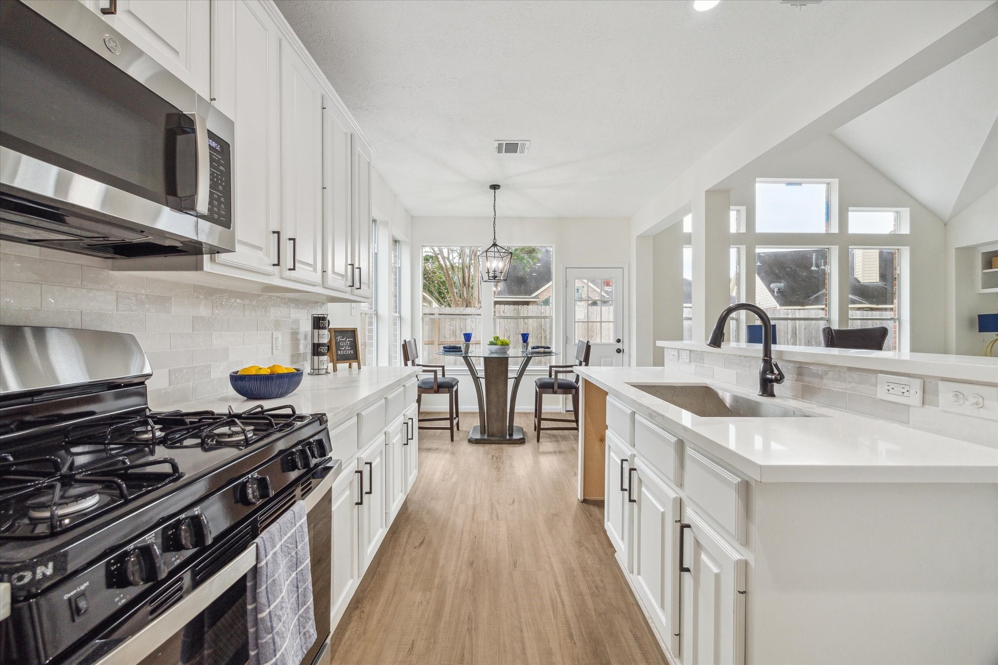 25403 Myrtle Springs Spring, TX 77373 - Photo 7 of 16 a kitchen with stainless steel appliances granite countertop a stove and a sink