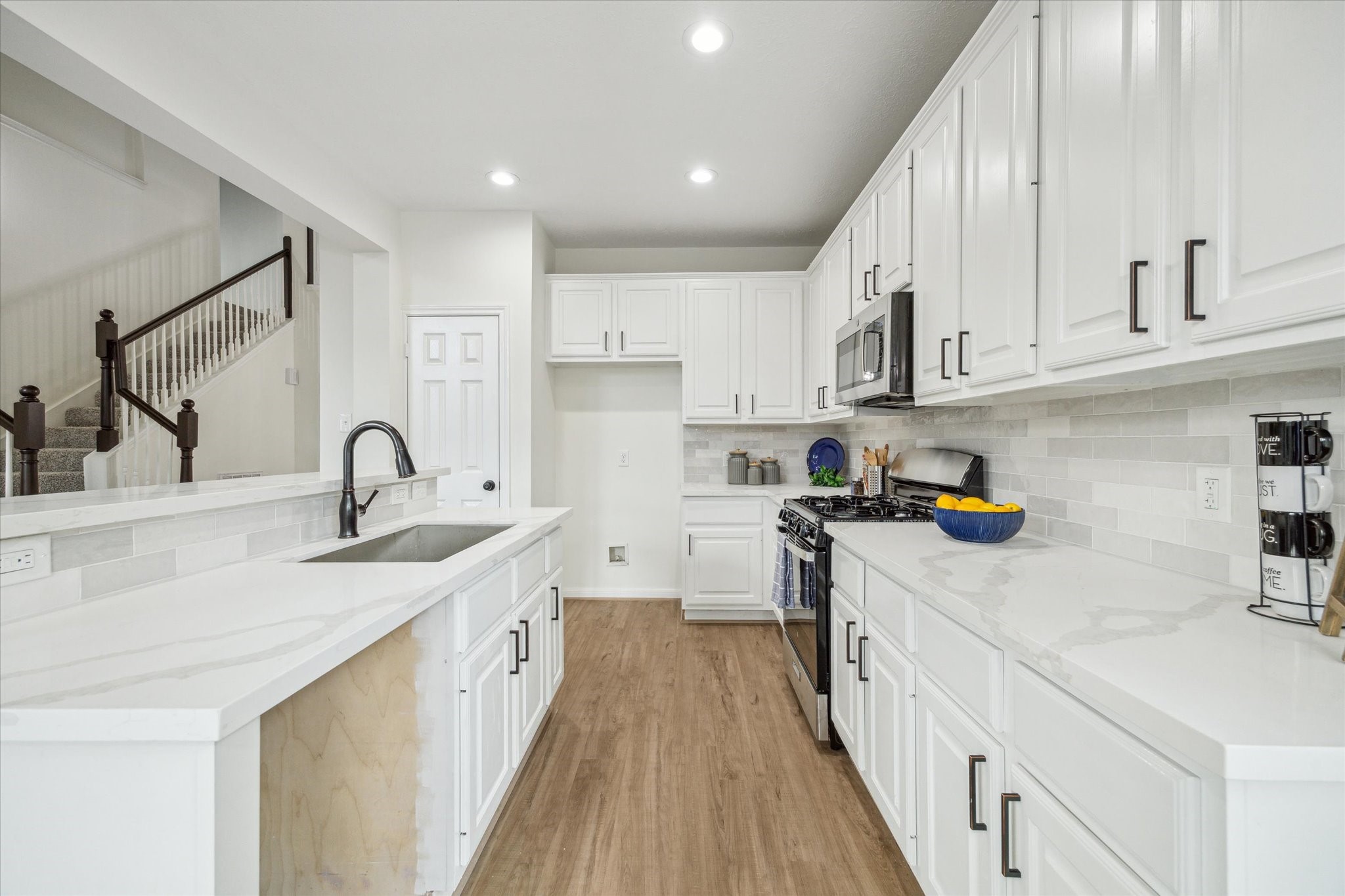 25403 Myrtle Springs Spring, TX 77373 - Photo 8 of 16 a kitchen with sink a stove and cabinets