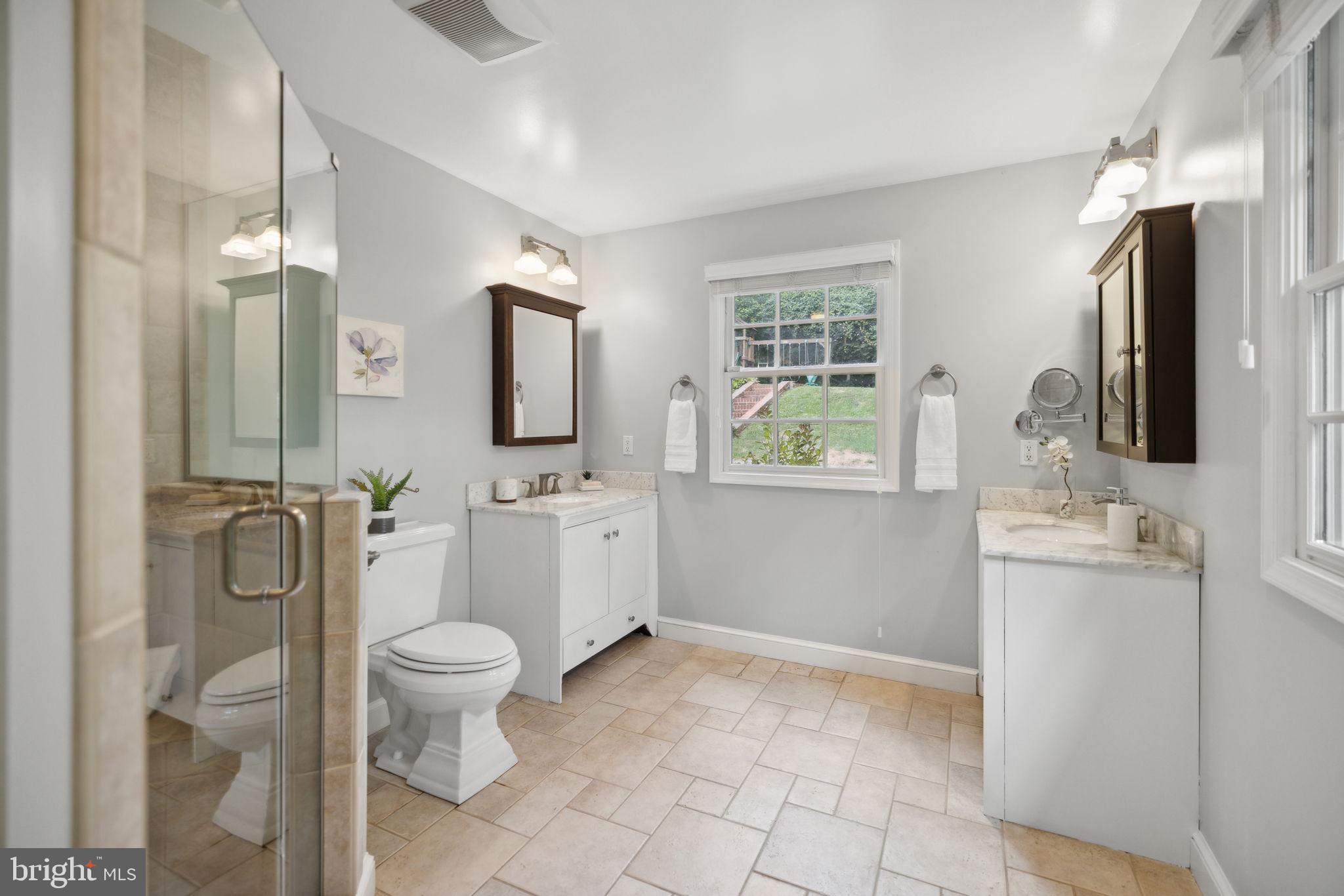 8012 Beech Tree Road Bethesda, MD 20817 - Photo 11 of 25 a bathroom with a toilet sink and mirror