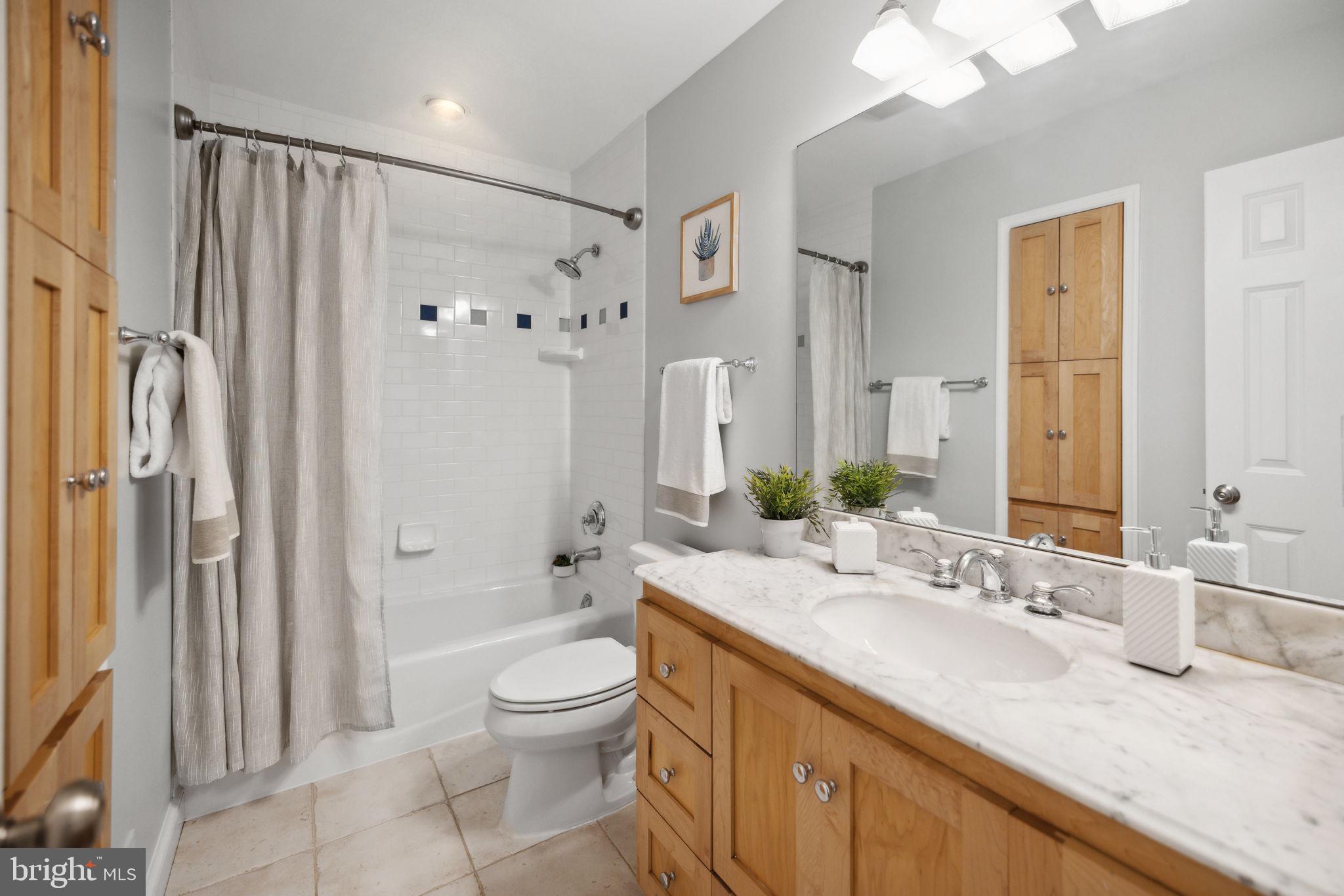 8012 Beech Tree Road Bethesda, MD 20817 - Photo 15 of 25 a bathroom with a granite countertop sink toilet and shower