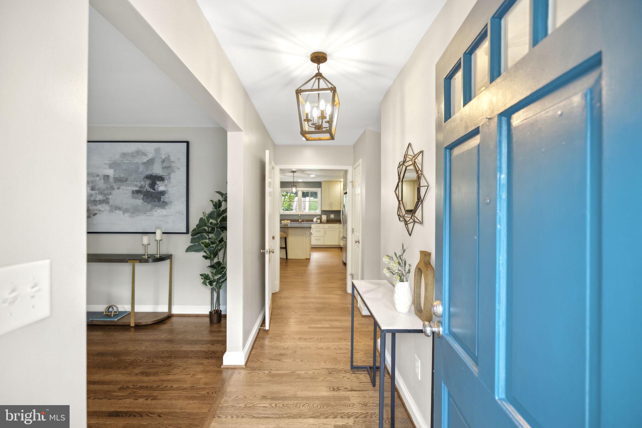8012 Beech Tree Road Bethesda, MD 20817 - Photo 2 of 25 a view of a hallway with wooden floor windows and livingroom