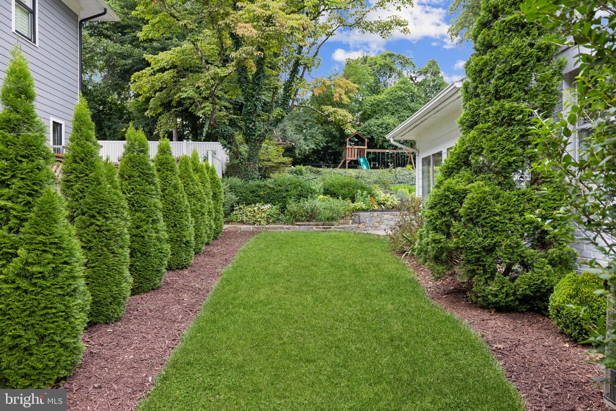 8012 Beech Tree Road Bethesda, MD 20817 - Photo 23 of 25 a view of a house with a yard and potted plants