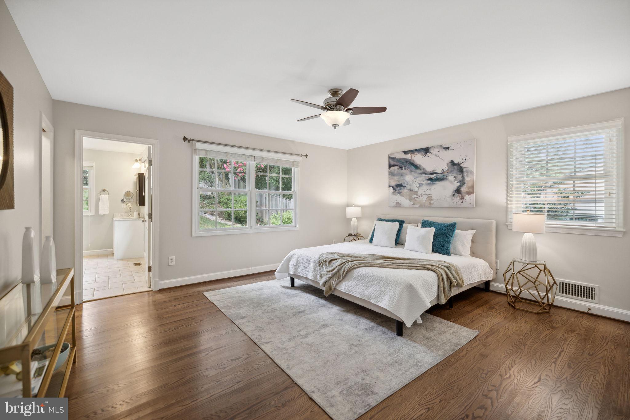 8012 Beech Tree Road Bethesda, MD 20817 - Photo 10 of 25 a spacious bedroom with a large bed and a window
