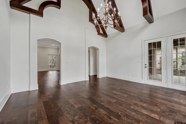 a view of an empty room with a fireplace and a window