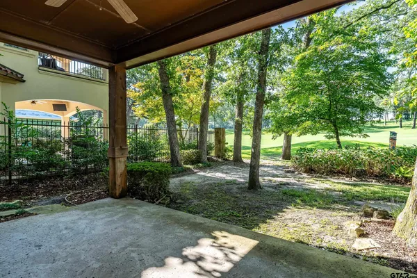 a view of a house with a big yard and large trees