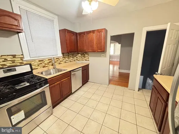 a kitchen with stainless steel appliances granite countertop a stove a refrigerator and a cabinets