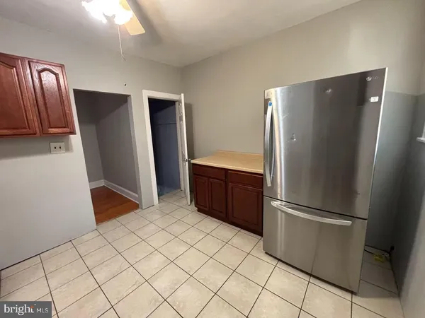 a kitchen with stainless steel appliances granite countertop a refrigerator and a stove
