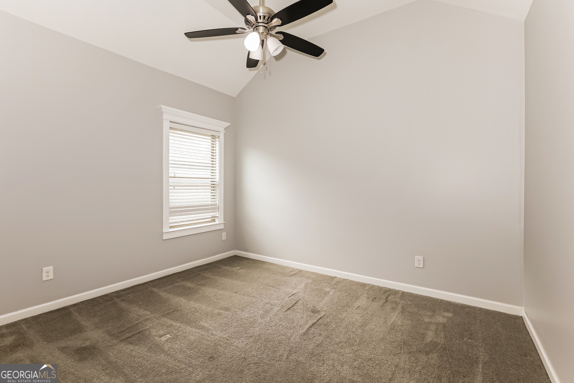 3216 Alhambra Circle Hampton, GA 30228 - Photo 17 of 21 an empty room with windows and fan view