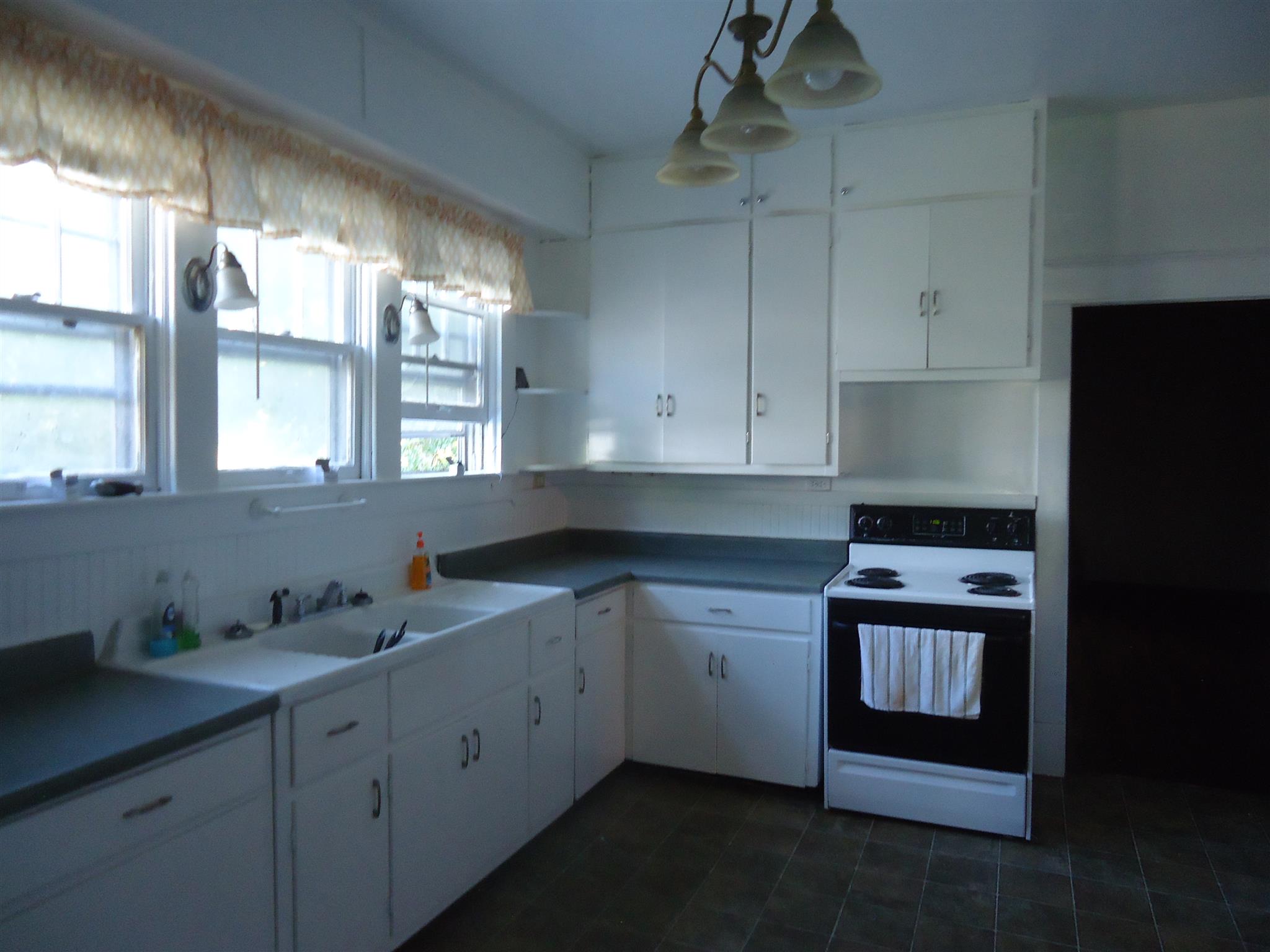 161 Bee Road Prospect, TN 38477 - Photo 15 of 19 a kitchen with stainless steel appliances granite countertop a sink a stove and a window