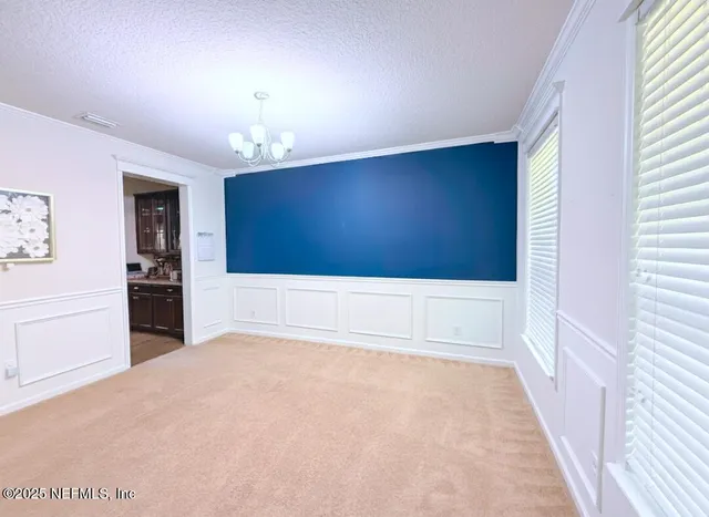a bedroom with a bed gym equipment and view of living room
