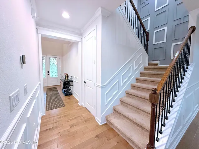 a living room with furniture and hard wood flooring
