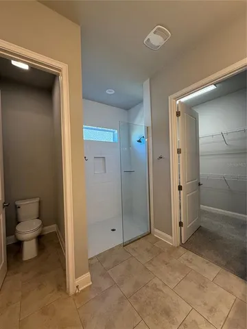 a bathroom with a toilet sink and shower