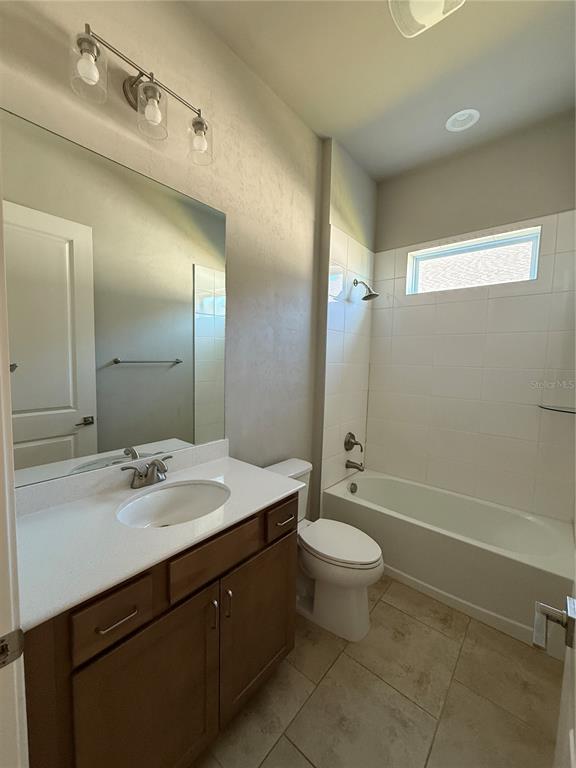 11822 Southwest 34th Road Gainesville, FL 32608 - Photo 16 of 24 a bathroom with a double vanity sink toilet mirror and shower