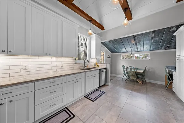 a kitchen with sink cabinets and window