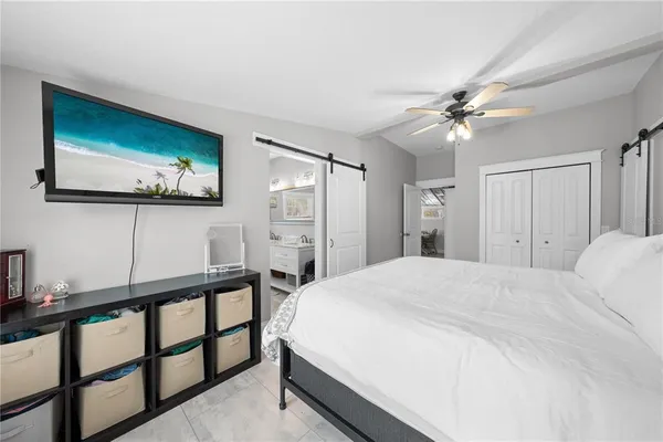 a bedroom with a bed and a flat screen tv