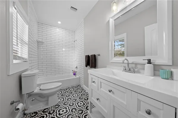 a bathroom with a sink toilet vanity and shower