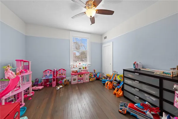 a play room with toys and a wooden floor