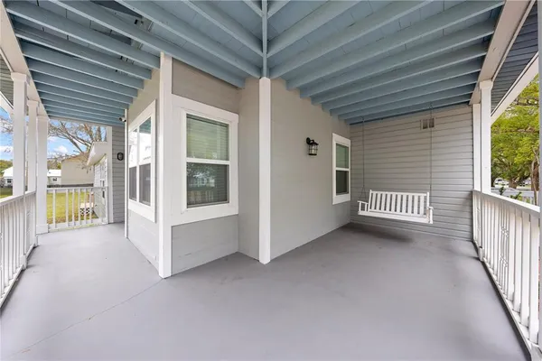 a white house that has a tree in front of it